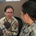 Cmdr. Braxton speaks to Canadian Lt. Cmdr. Davidson-Arnott about Mental Wellness on Deployments During Wellness Wednesday on AFN Bahrain