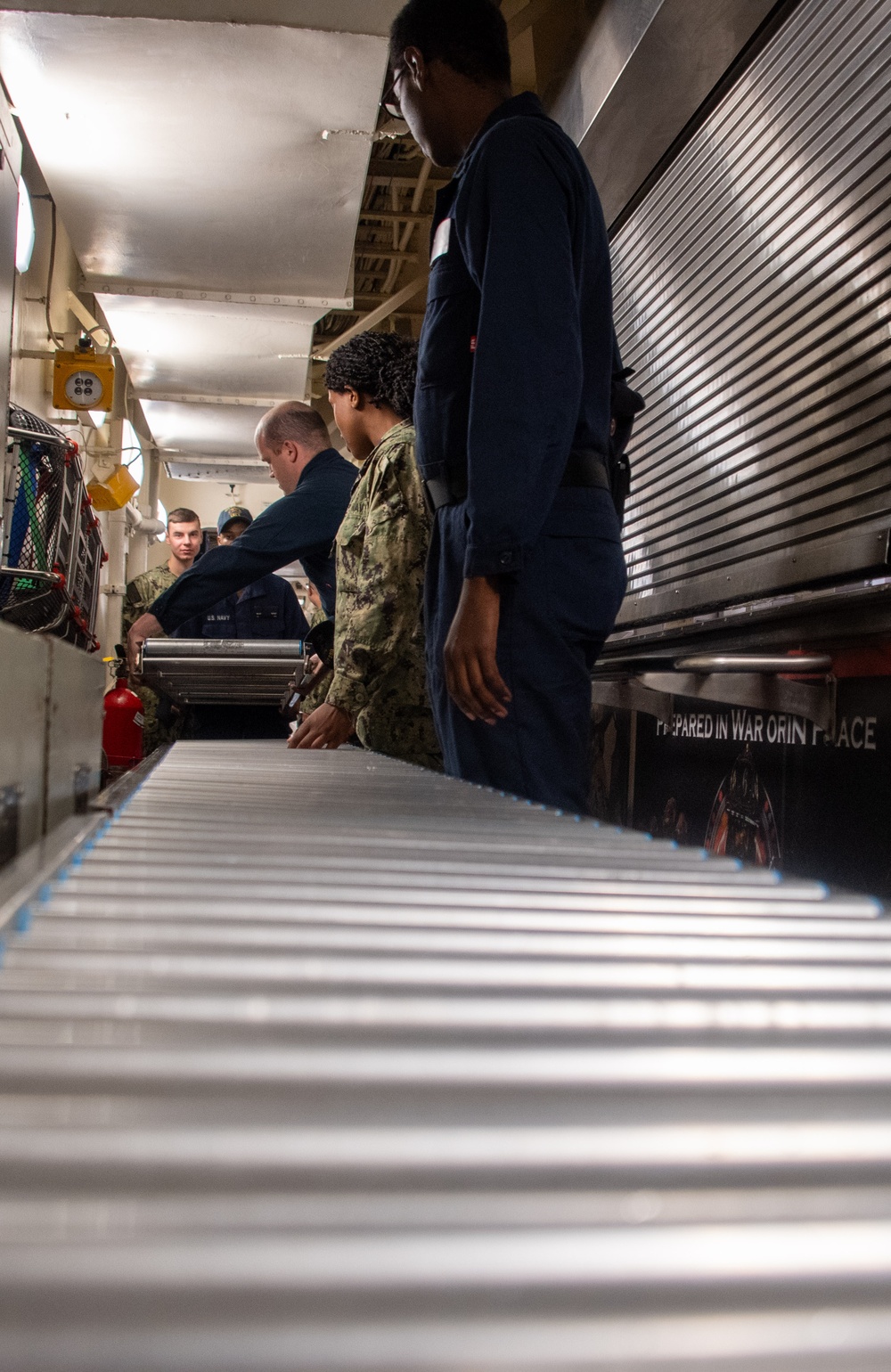 Sailors assigned to the USS America (LHA 6) particpate in cargo on load