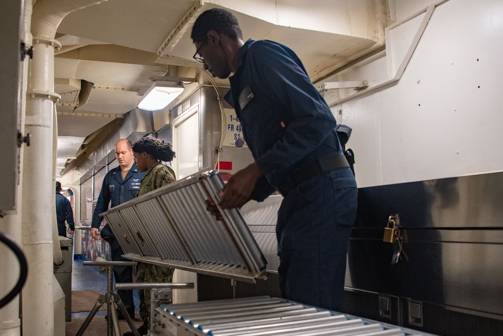 Sailors assigned to the USS America (LHA 6) participate in cargo on load