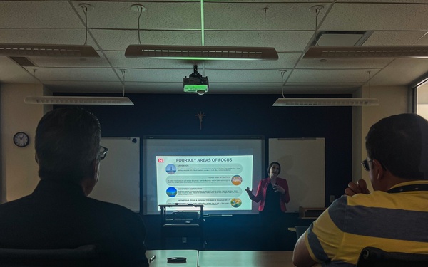 Two people listen to presentation