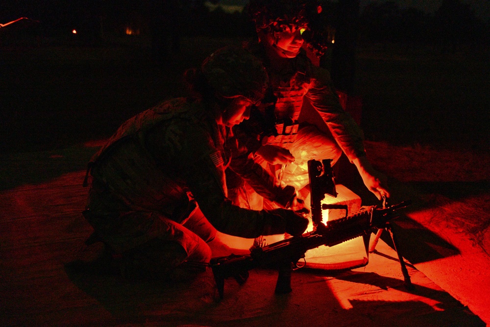 Combat medics use the M249 light machine gun during a field observational assessment