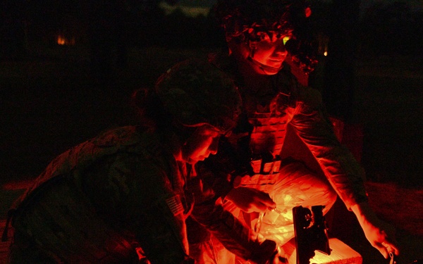 Combat medics use the M249 light machine gun during a field observational assessment