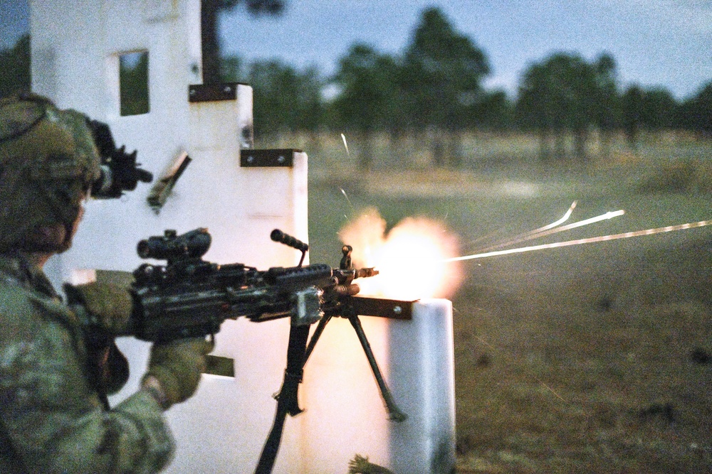 Combat medics use the M249 light machine gun during a field observational assessment