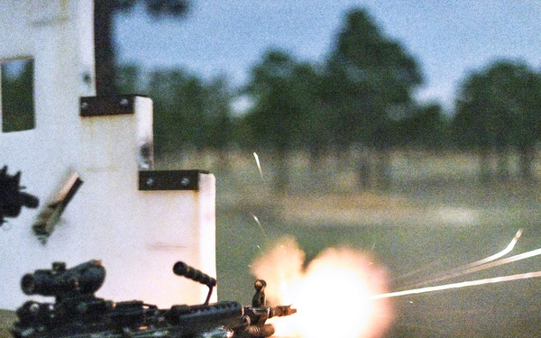 Combat medics use the M249 light machine gun during a field observational assessment