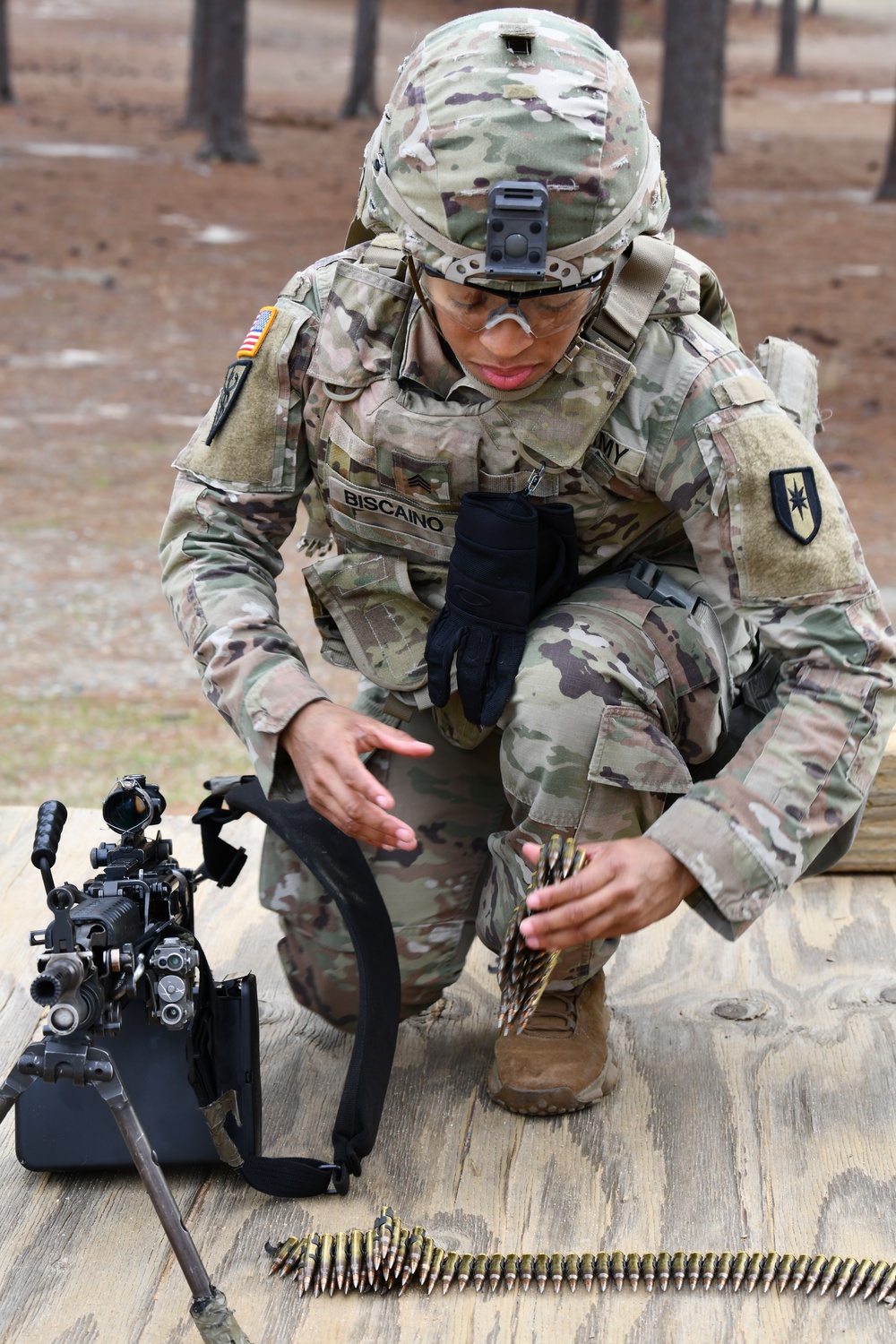 Combat medics use the M249 light machine gun during a field observational assessment