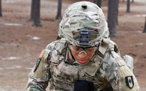 Combat medics use the M249 light machine gun during a field observational assessment