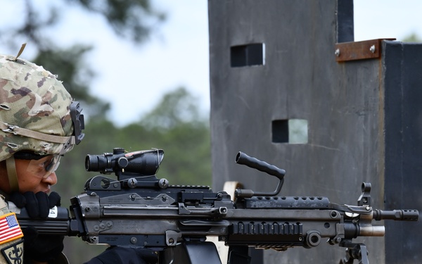 Combat medics use the M249 light machine gun during a field observational assessment