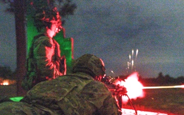 Combat medics use the M249 light machine gun during a field observational assessment