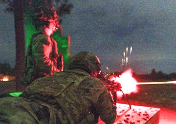 Combat medics use the M249 light machine gun during a field observational assessment