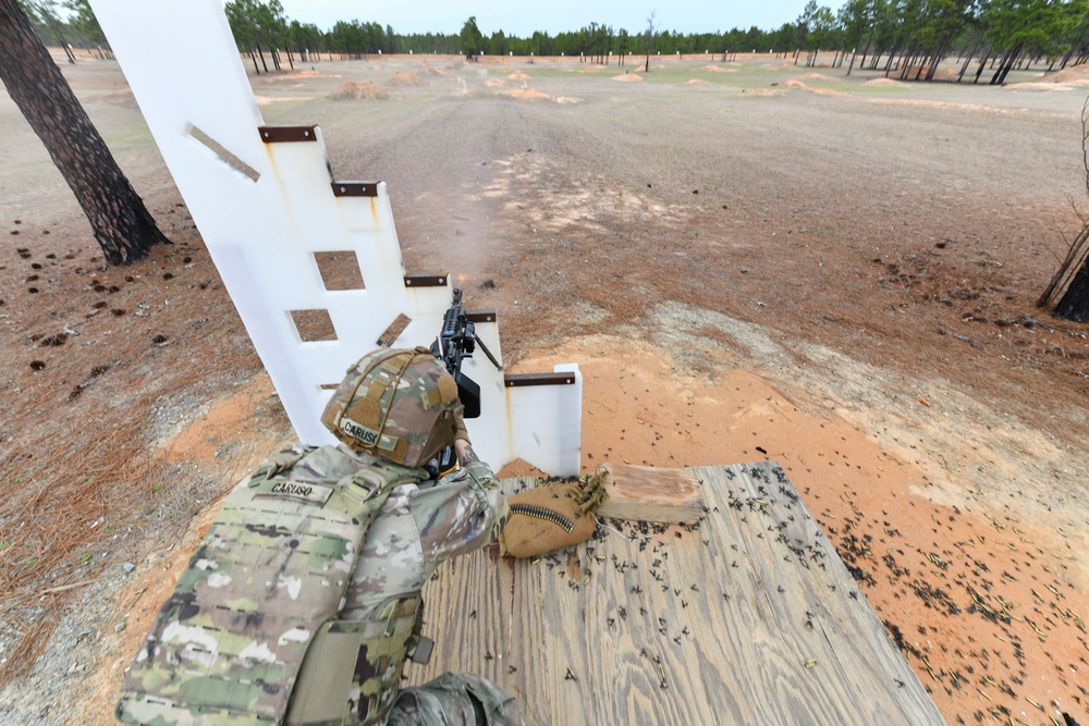 Combat medics use the M249 light machine gun during a field observational assessment