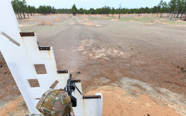 Combat medics use the M249 light machine gun during a field observational assessment