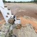 Combat medics use the M249 light machine gun during a field observational assessment