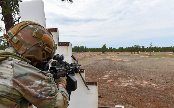 Combat medics use the M249 light machine gun during a field observational assessment