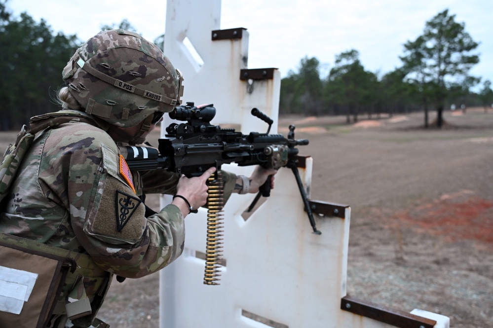 Combat medics use the M249 light machine gun during a field observational assessment