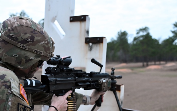 Combat medics use the M249 light machine gun during a field observational assessment