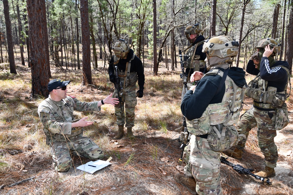 Combat medics use the M249 light machine gun during a field observational assessment