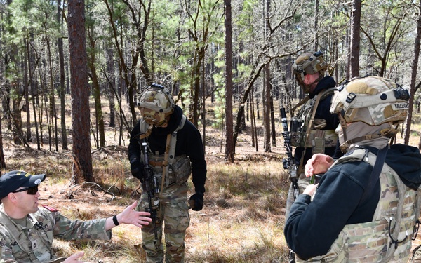 Combat medics use the M249 light machine gun during a field observational assessment