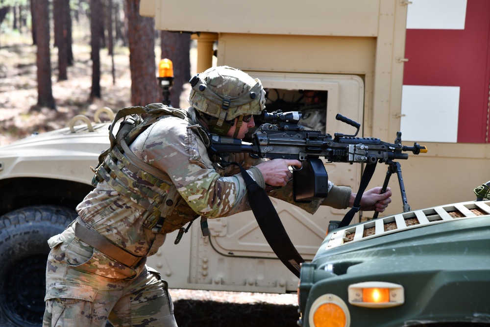 Combat medics use the M249 light machine gun during a field observational assessment