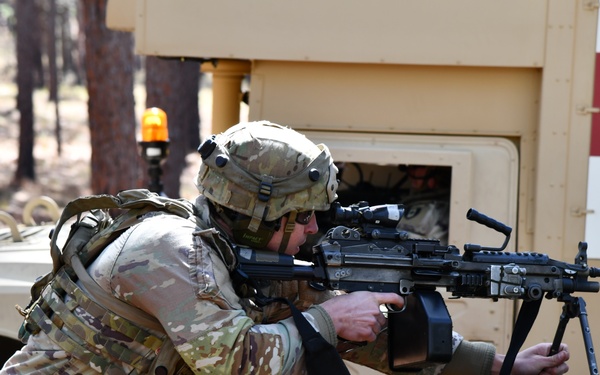 Combat medics use the M249 light machine gun during a field observational assessment