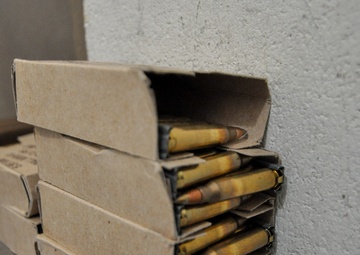 Boxed rounds of 5.56 ammunition wait for qualification shooters