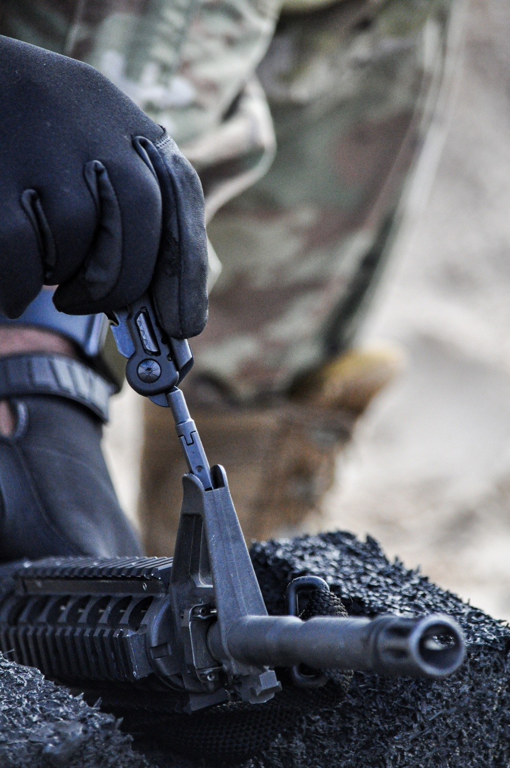 Soldier makes front sight adjustments during Best Squad competition