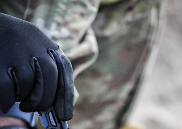 Soldier makes front sight adjustments during Best Squad competition
