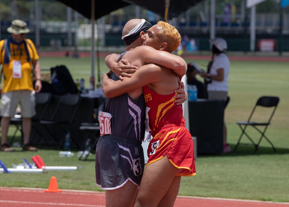 Athletes of Team Marine Corps and Team SOCOM Hug Each Other During 2024 DoD Warrior Games