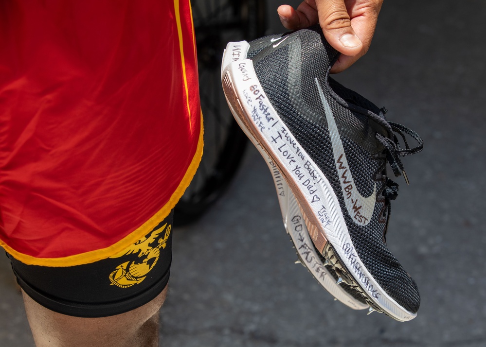 Marine Corps Master Sgt. Brian Hernandez Holds Sneakers Signed by Family During 2024 DoD Warrior Games