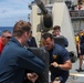 Sailors aboard the USS Howard participate in a sea contamination exercise in the East China Sea