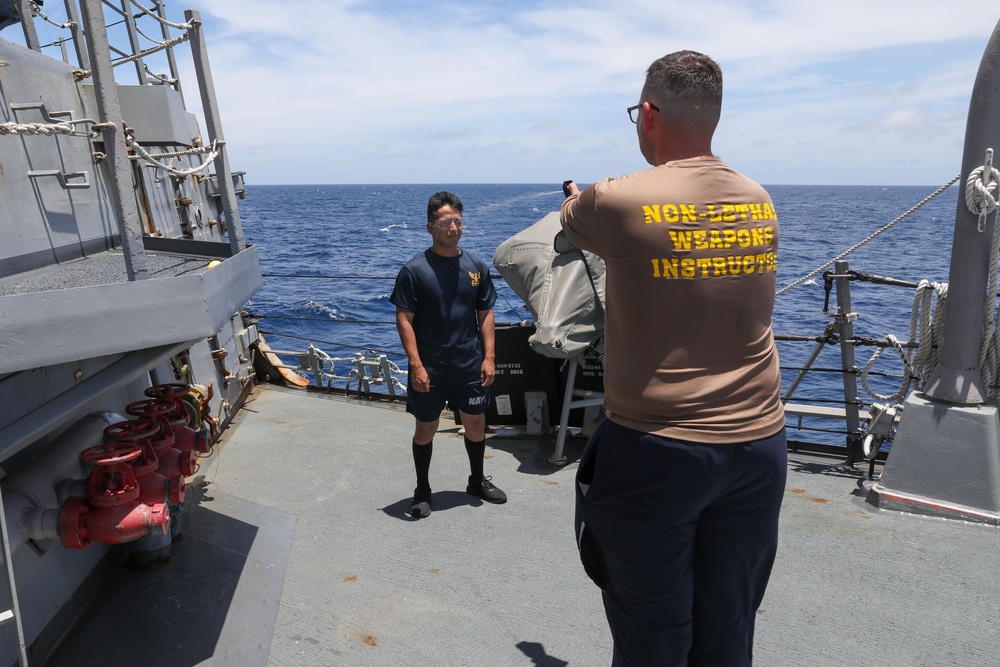 Sailors aboard the USS Howard participate in a sea contamination exercise in the East China Sea