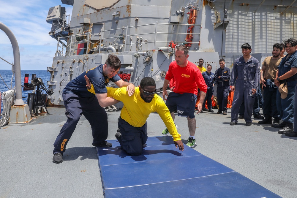 Sailors aboard the USS Howard participate in a sea contamination exercise in the East China Sea