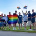 Sailors, Staff, and Community Members Take a Photo Together During a Pride Month Celebration at CTF 75