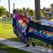 Staff and Sailors Hold Flags During a Pride Event on Camp Covington