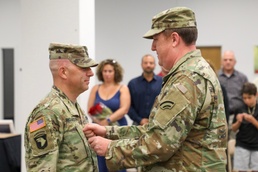 New York Army National Guard Col. Marshall Hunt pins new rank onto Command Sergeant Major Michael Richardson