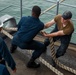 Abraham Lincoln sailors heave in lines
