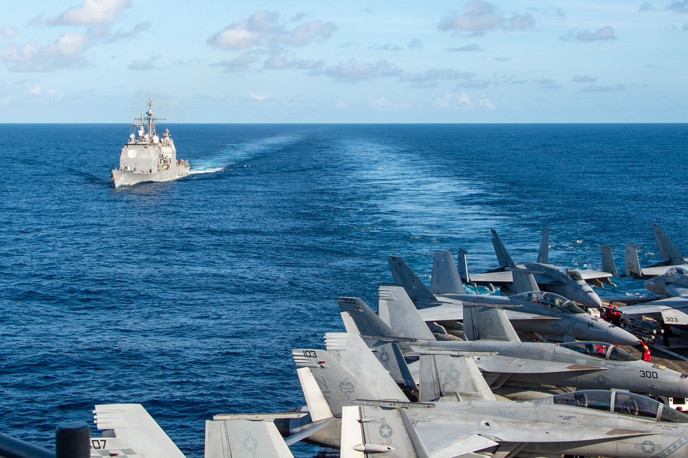 USS Ronald Reagan (CVN 76) conducts fueling-at-sea with USS Robert Smalls (CG 62)