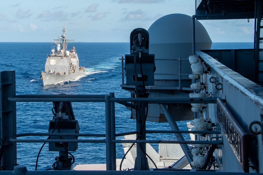 USS Ronald Reagan (CVN 76) conducts fueling-at-sea with USS Robert Smalls (CG 62)