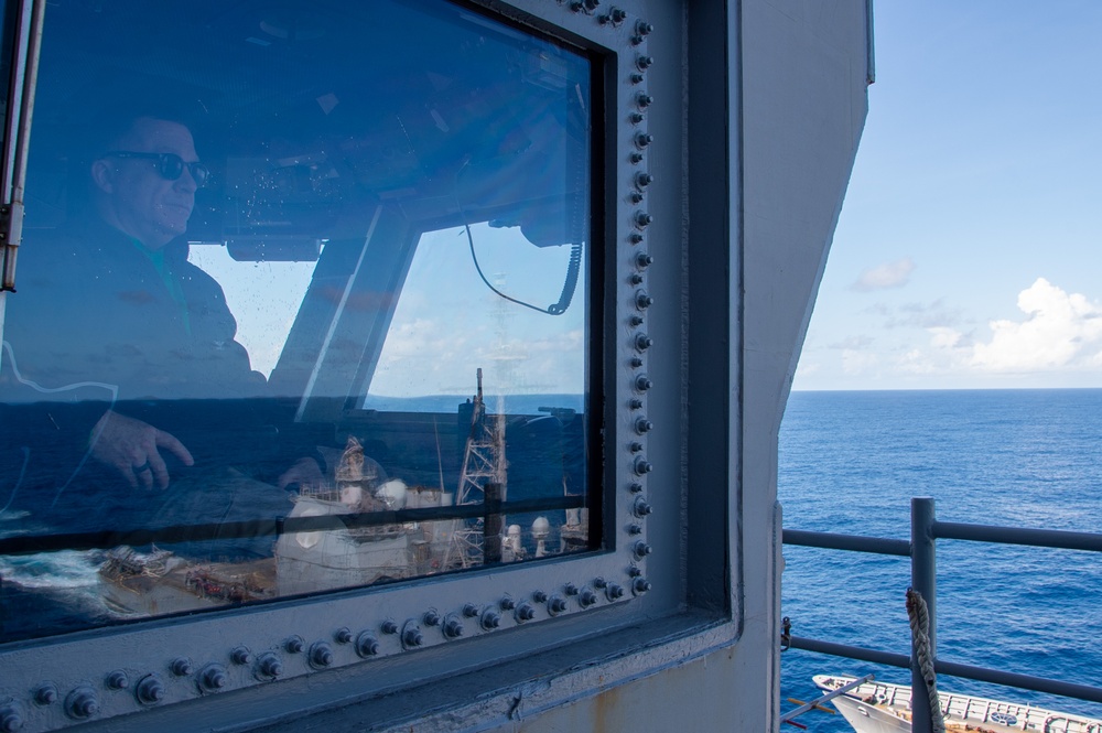 USS Ronald Reagan (CVN 76) conducts fueling-at-sea with USS Robert Smalls (CG 62)