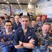 Carrier Strike Group 5, Japan Maritime Self-Defense Force, Royal Australian Navy, and Royal Australian Air Force information warfare leaders and specialists pose for group photo aboard USS Ronald Reagan