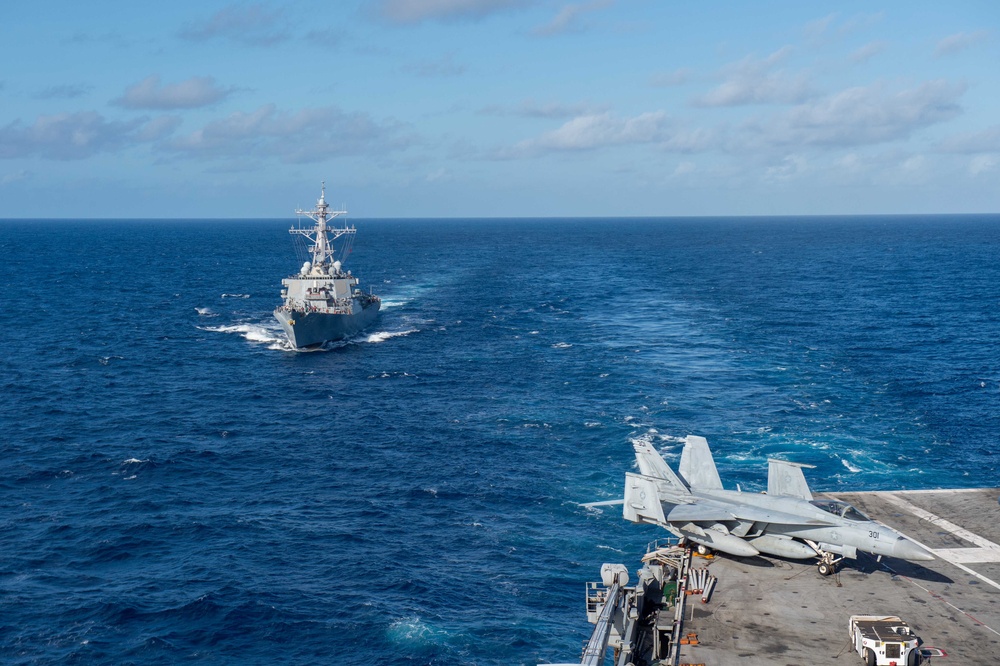 USS Ronald Reagan (CVN 76) conducts fueling-at-sea with USS Curtis Wilbur (DDG 54)