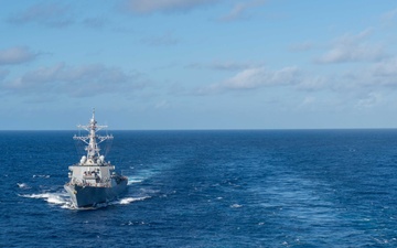 USS Ronald Reagan (CVN 76) conducts fueling-at-sea with USS Curtis Wilbur (DDG 54)