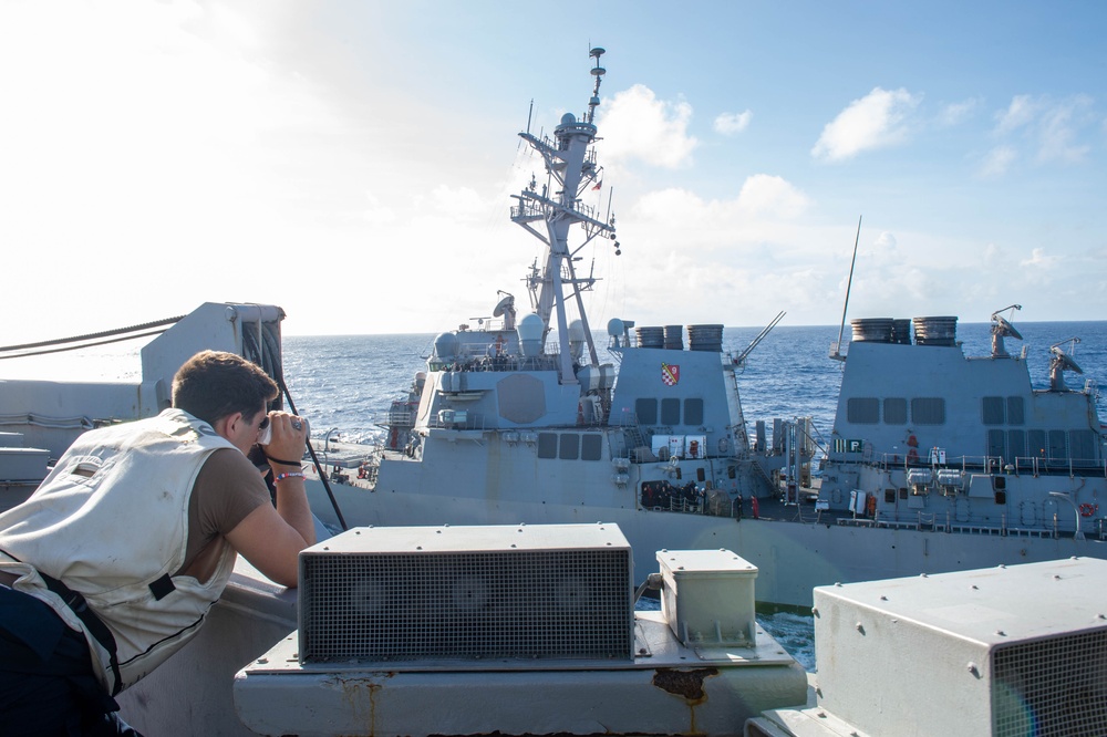 USS Ronald Reagan (CVN 76) conducts fueling-at-sea with USS Curtis Wilbur (DDG 54)