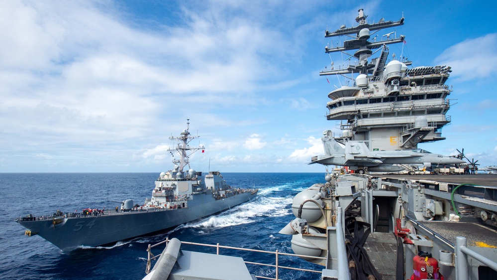 USS Ronald Reagan (CVN 76) conducts fueling-at-sea with USS Curtis Wilbur (DDG 54)