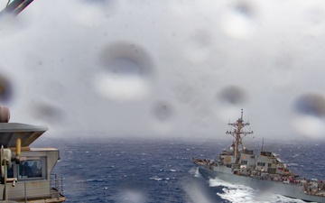 USS Ronald Reagan (CVN 76) conducts fueling-at-sea with USS Curtis Wilbur (DDG 54)