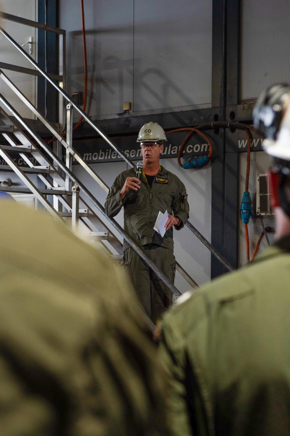 Capt. J. Patrick Thompson, commanding officer of the Nimitz-class aircraft carrier USS John C. Stennis (CVN 74), speaks to the crew during an all hands call