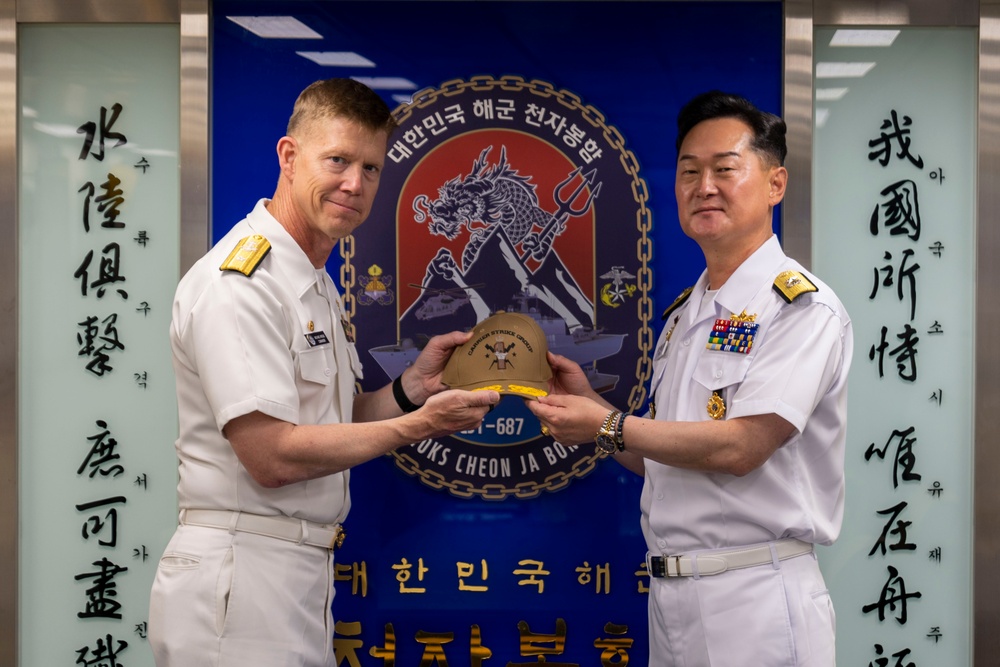 Rear Adm. Michael Wosje Presents a Gift to Republic of Korea Navy Rear Adm. Sung Jae Hur During RIMPAC 2024