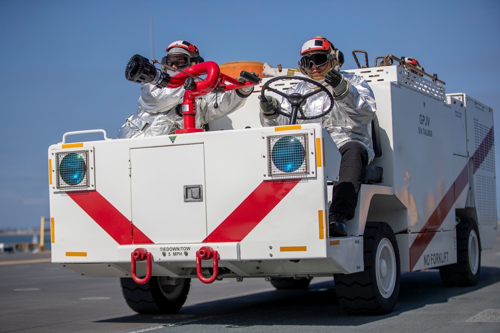 USS Tripoli Sailors execute fire deck firefighting drill