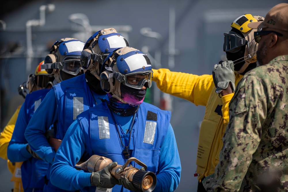 USS Tripoli Sailors execute fire deck firefighting drill