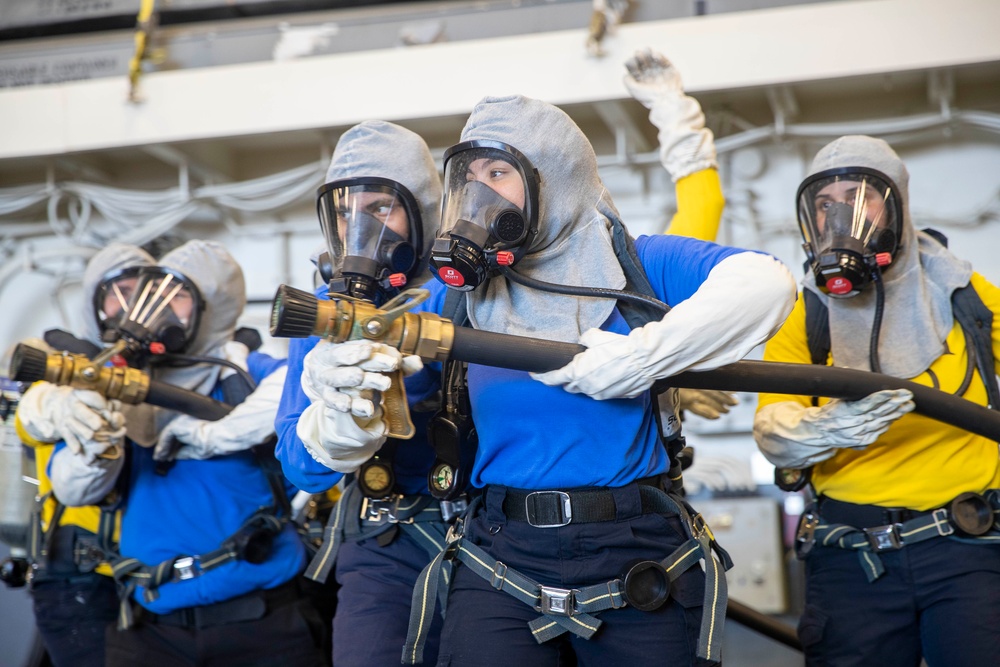 USS Tripoli Sailors execute fire deck firefighting drill