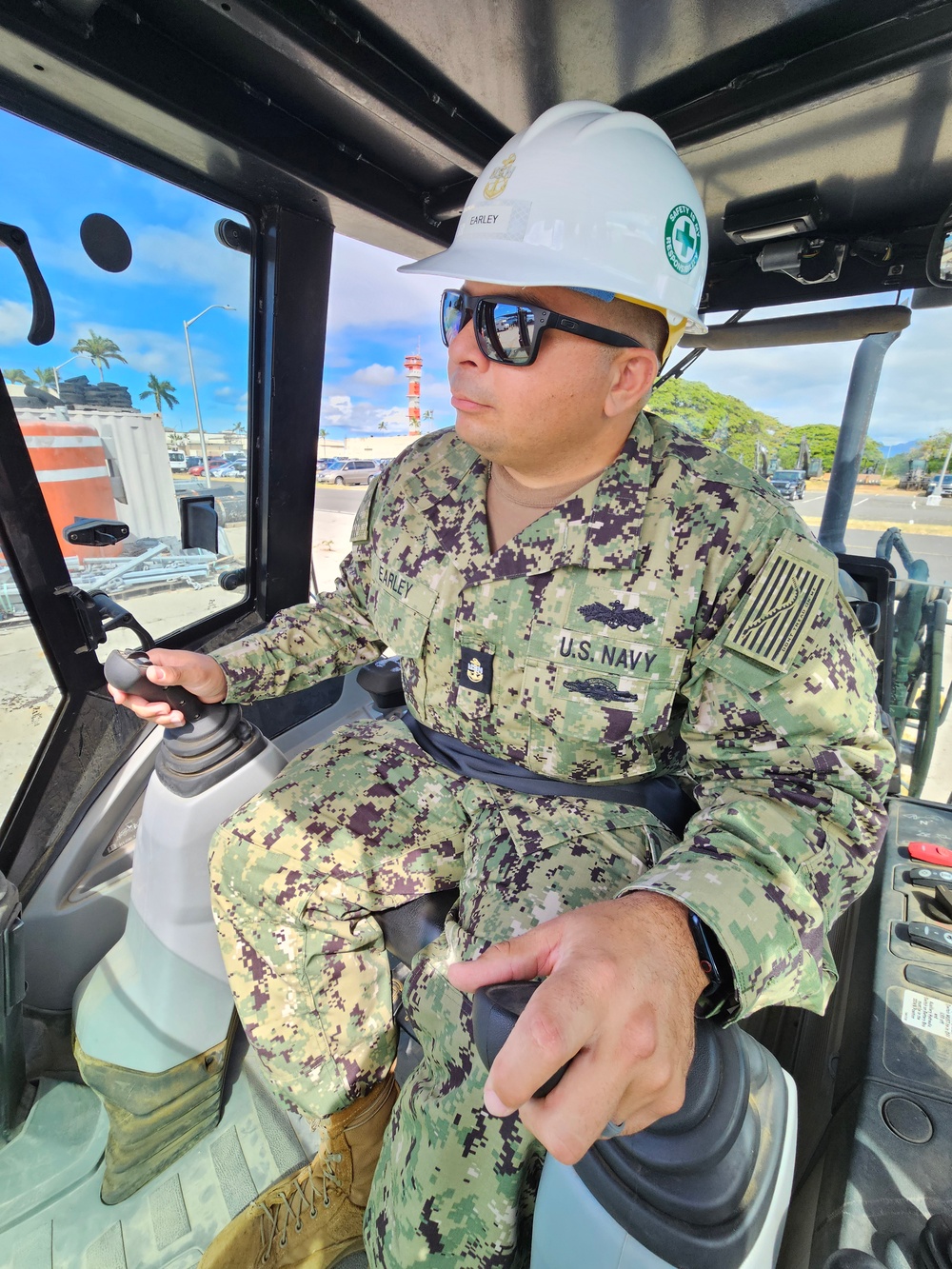 EOC Earley operates an excavator at Joint Base Pearl Harbor-Hickam during RIMPAC 2024